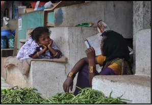 Araku Valley — a mother and her child selling vegetables at a market stall